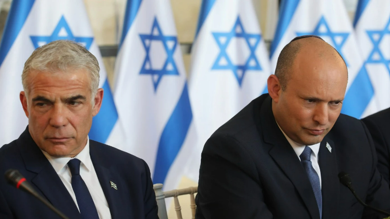 Israeli Prime Minister Naftali Bennett, right, and Foreign Minister Yair Lapid, attend a weekly cabinet meeting in Jerusalem on May 29, 2022.