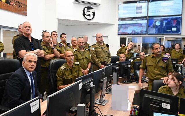 Prime Minister Yair Lapid and Defense Minister Benny Gantz tour the IDF’s Southern Command on August 7, 2022, amid fighting in the Gaza Strip between Israel and the Palestinian Islamic Jihad terror group. (Haim Zach/GPO)