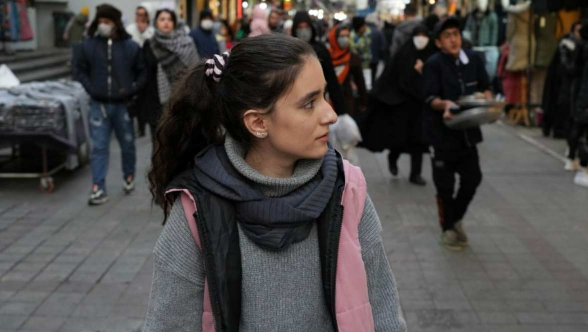 AP Photo/Vahid Salemi A woman walks around a commercial district without wearing her mandatory Islamic headscarf in downtown Tehran, Iran, on Dec. 23, 2022. Iran has been gripped by nationwide protests since September, after the death of a young woman in the custody of morality police for allegedly not observing the mandatory hijab.
